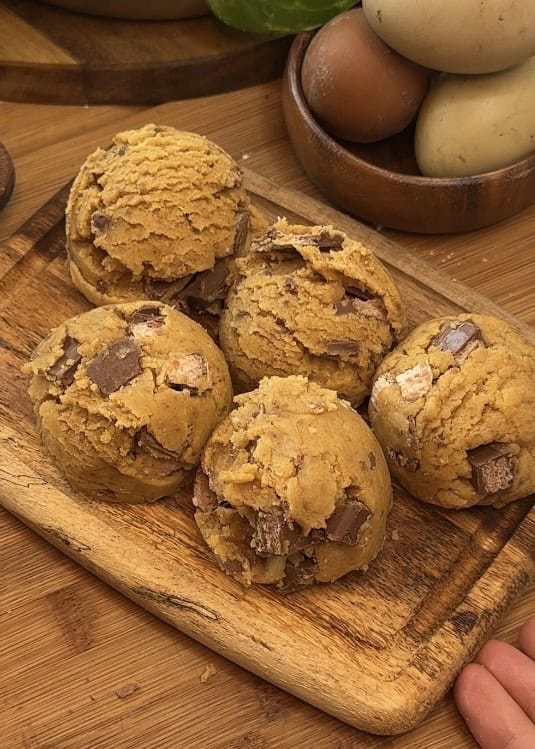 Perfectly scooped Copycat Crumbl KitKat cookie dough on a tray, just frozen and ready to be baked.