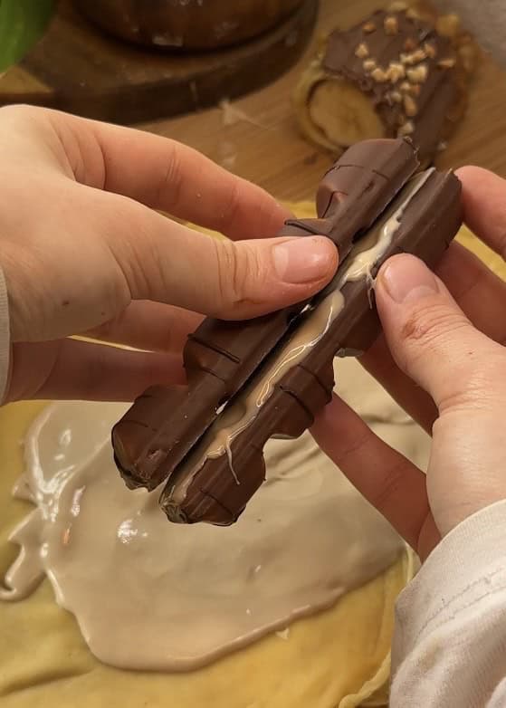 Close-up of two whole Kinder Buenos joined together with Kinder Bueno spread, ready to be placed inside a sushi crepe roll.