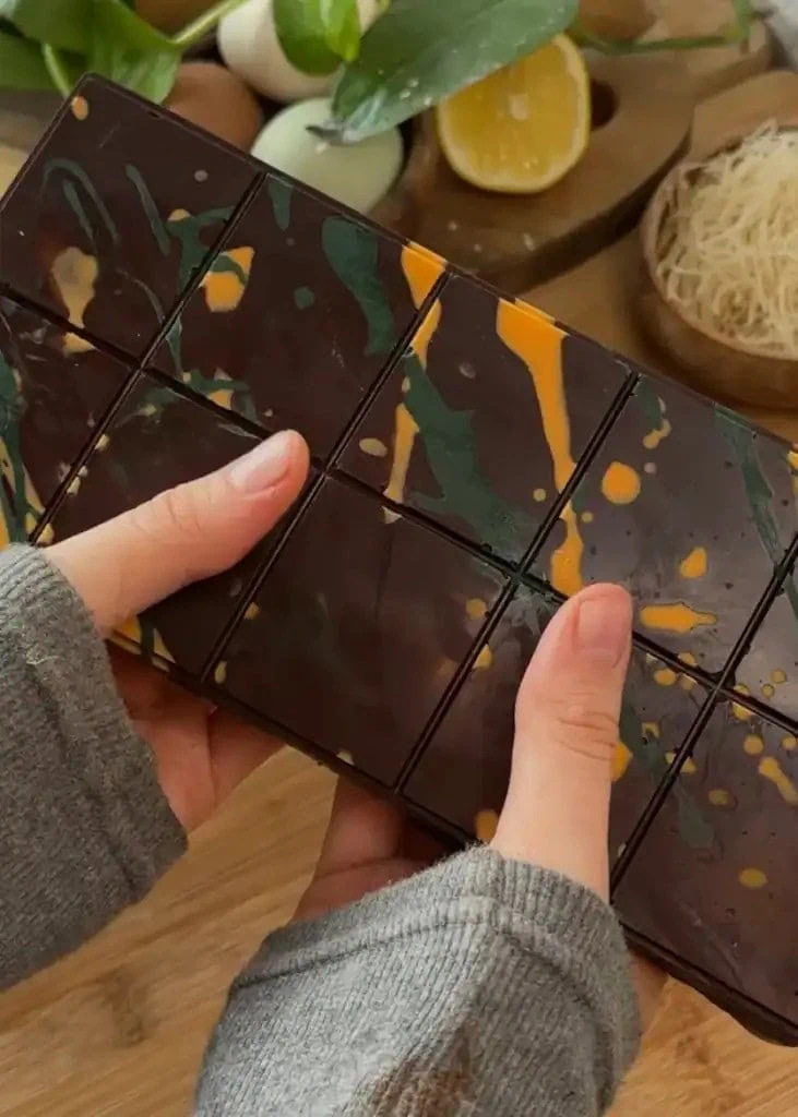 Finished homemade Dubai chocolate bar with a glossy chocolate coating, showcasing its luxurious design and hidden layers of crunchy kataifi pastry and creamy pistachio filling