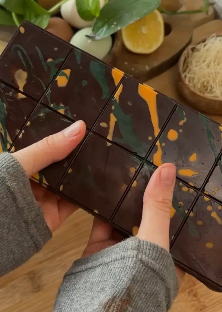 Finished homemade Dubai chocolate bar with a glossy chocolate coating, showcasing its luxurious design and hidden layers of crunchy kataifi pastry and creamy pistachio filling