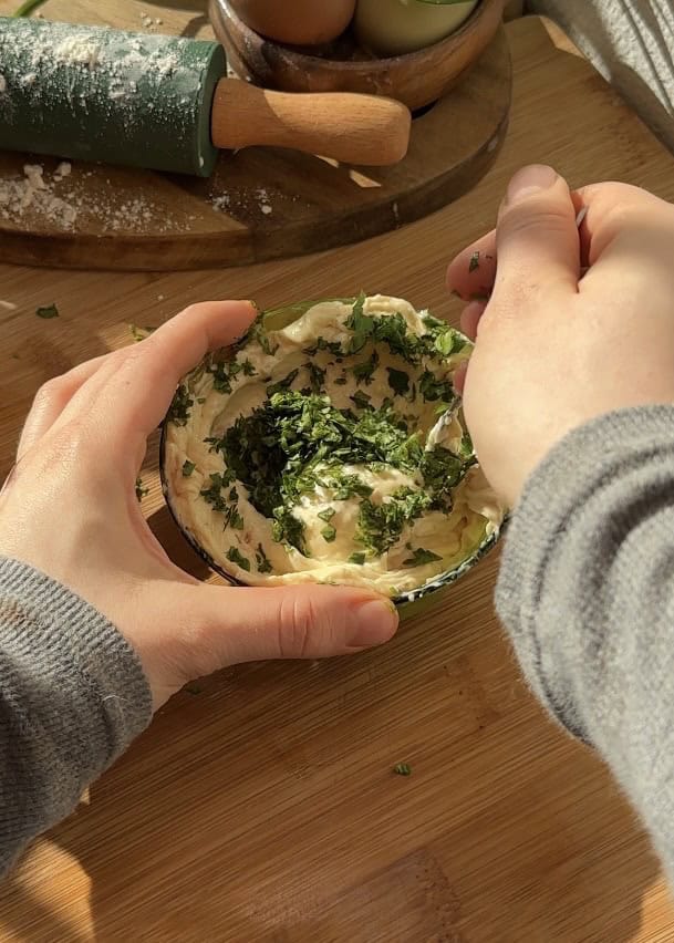 Buttery cheese garlic rolls before baking, filled with mozzarella cheese, garlic butter inside, and topped with fresh parsley.