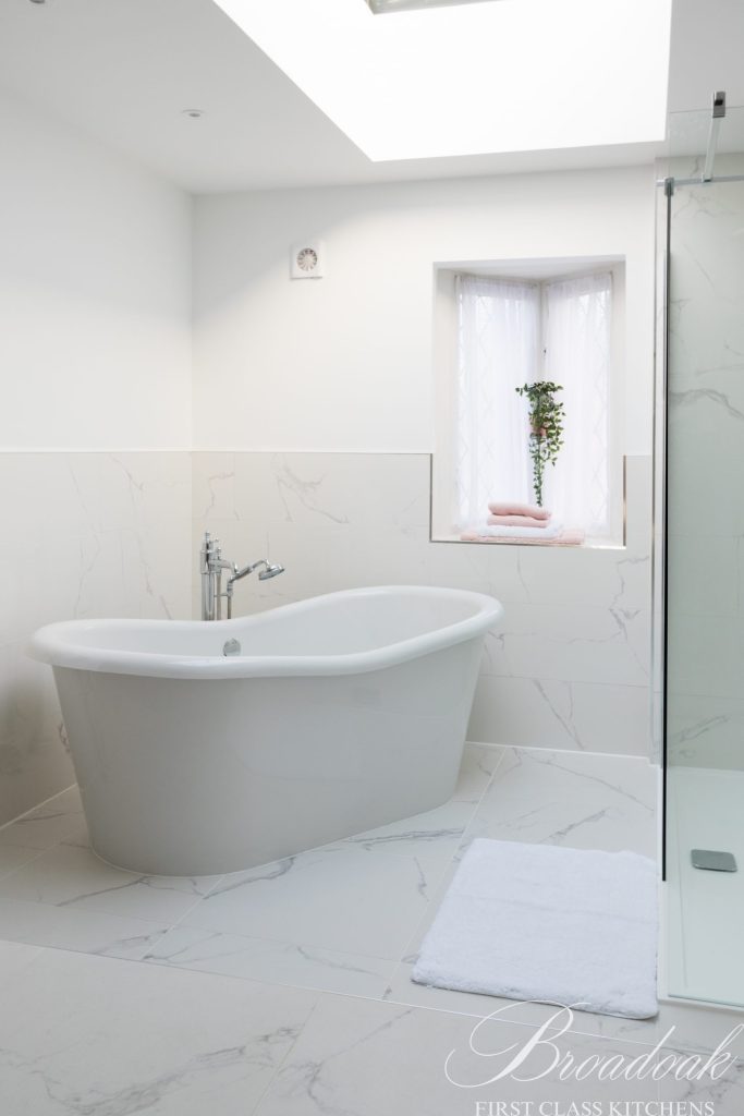 Luxurious modern bathroom with white marble tiles, freestanding bathtub, and walk-in shower, showcasing high-end bathroom design and premium bathroom fixtures.
