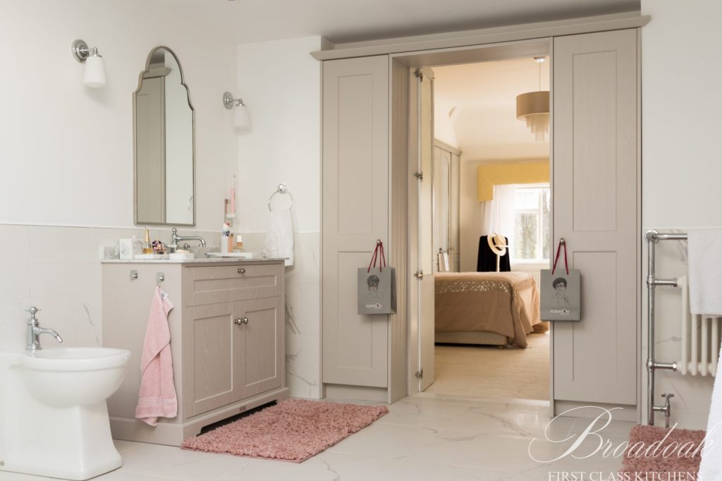 Bright and elegant bathroom with beige fixtures, stylish cabinetry, and modern accents, showcasing high-end bathroom renovation by Broadoak Kitchens Ltd. for a luxurious home upgrade.