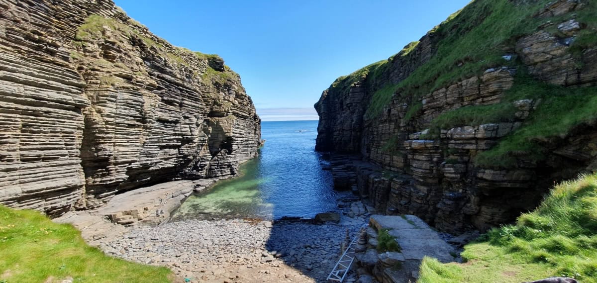 Rocky cliffs and a body of water.