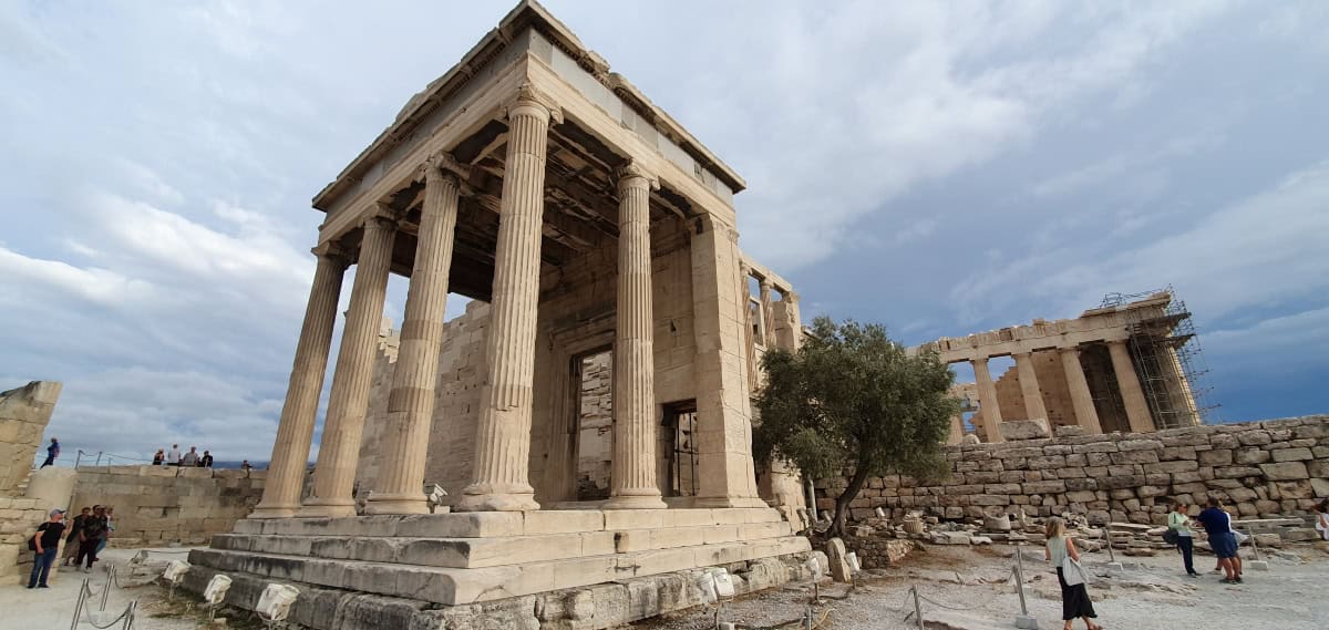 View of the Erechtheion with the Parthenon in the background.