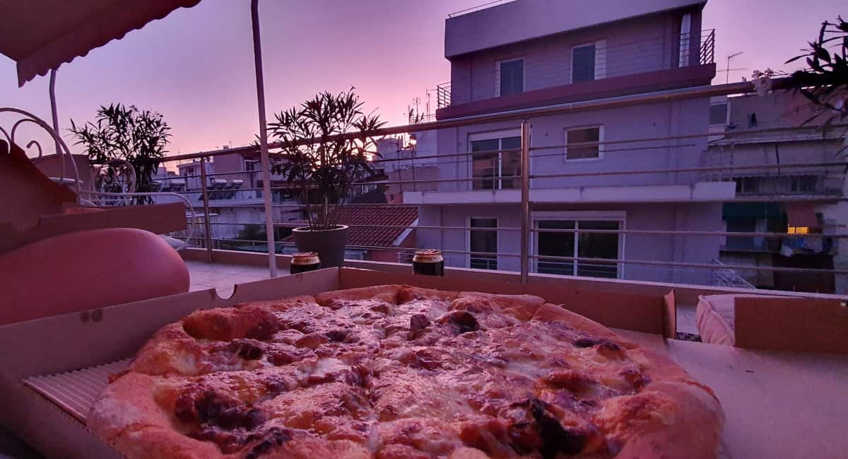 Pizza with view to other apartment blocks.
