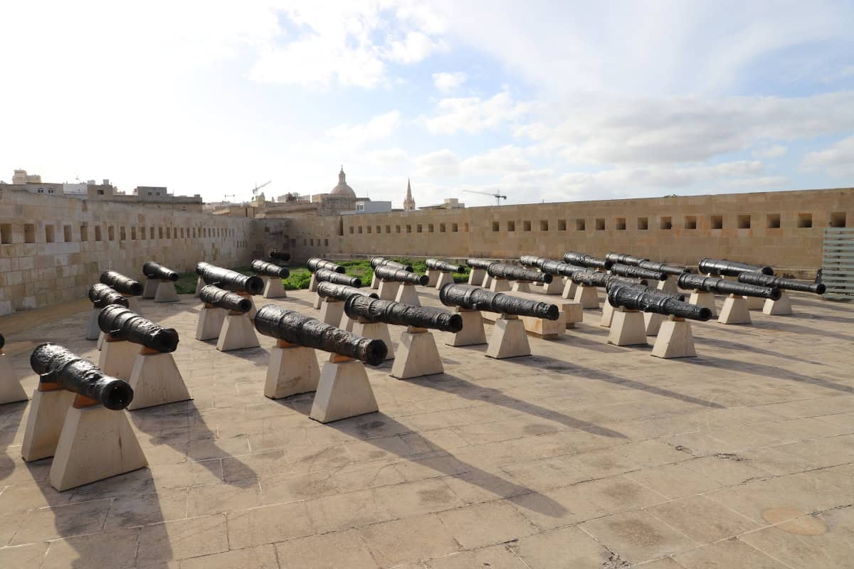 Historical cannons on rooftop terrace in Valletta, Malta, part of The Wandering Woodward travel blog.