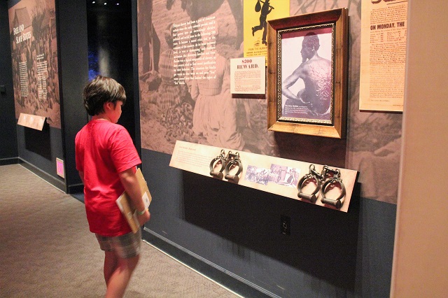 Learning about the slave auction at the Abraham Lincoln Museum.