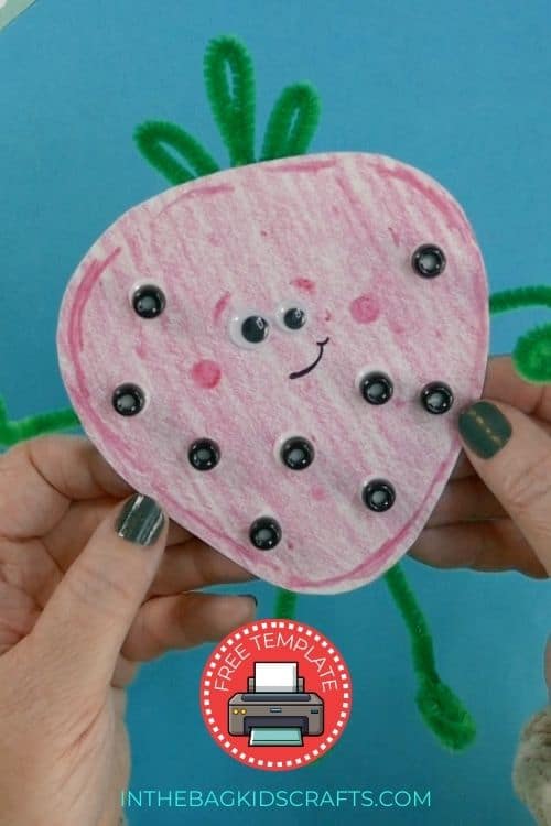 A fun and easy strawberry craft made with pink coloring, green pipe cleaners, and black beads, perfect as a spring craft for kids.
