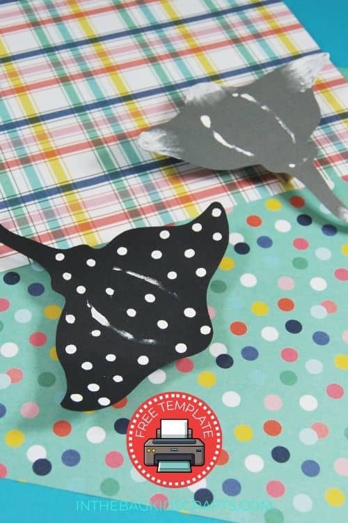 A hand holds a spotted paper stingray craft, perfect for an ocean crafts for kids activity and an easy paper craft project.