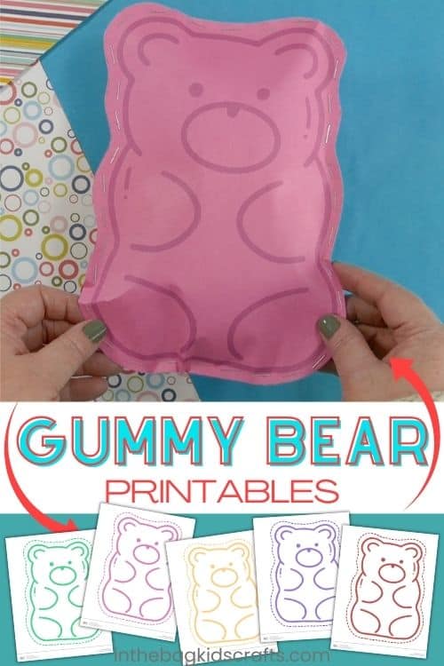 A pink candy gummy bear craft made from paper, stitched around the edges, displayed on a blue background with patterned scrapbook paper, making it a fun paper craft for kids.