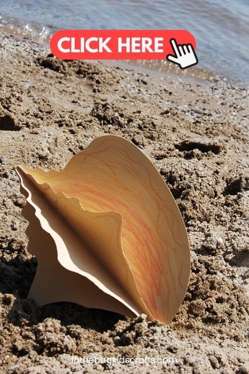 Two hands holding a three-dimensional paper conch shell colored in warm tones, representing a creative conch shell craft and beach craft for kids.