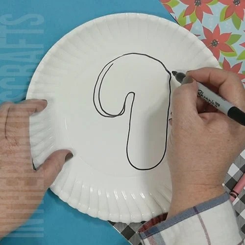 A colorful Christmas craft featuring a simple candy cane craft, perfect as an easy craft for kids during the holiday season. Step 1 drawing the candy cane.