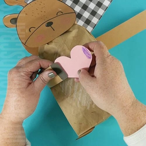 deer craft final step holding a heart 
