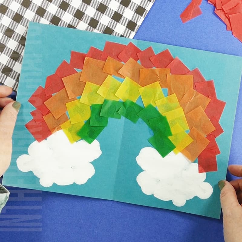 Easy Rainbow Craft made with squish painted clouds and tissue paper rainbow