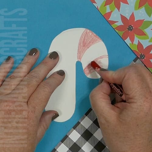 A colorful Christmas craft featuring a simple candy cane craft, perfect as an easy craft for kids during the holiday season.  Step 3 color the candy cane
