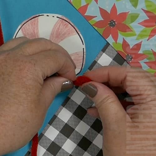 A colorful Christmas craft featuring a simple candy cane craft, perfect as an easy craft for kids during the holiday season.  step 6 creating the hands and feet of the candy cane
