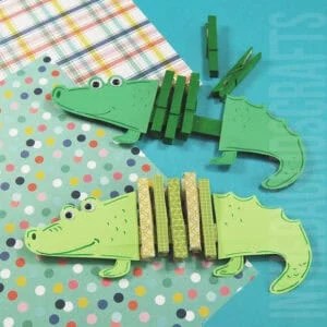 Two green paper alligators made with painted clothespins and cardstock are displayed on colorful patterned backgrounds, showing a playful and creative alligator craft for kids.