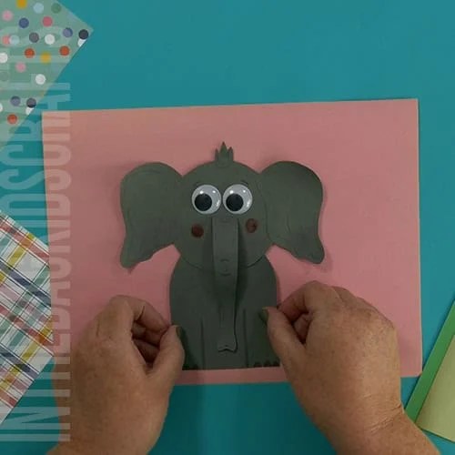 Paper elephant craft step 5 placing the elphant on the page 