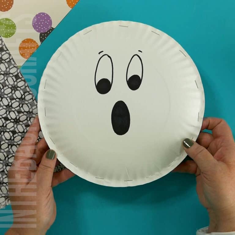 An image showing a simple paper plate ghost craft, perfect for an easy Halloween craft and fun preschool activity for kids.