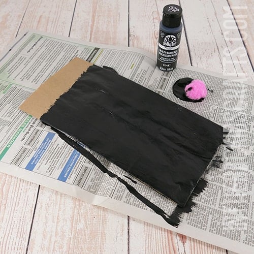 painting the paper lunch bag black 