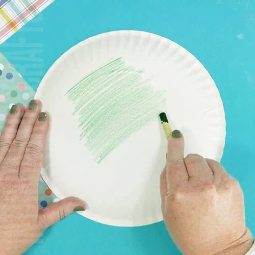 A simple and fun pickle craft for kids, featuring an easy food-themed project perfect for holiday crafting or anytime creativity. step 1 coloring the plate
