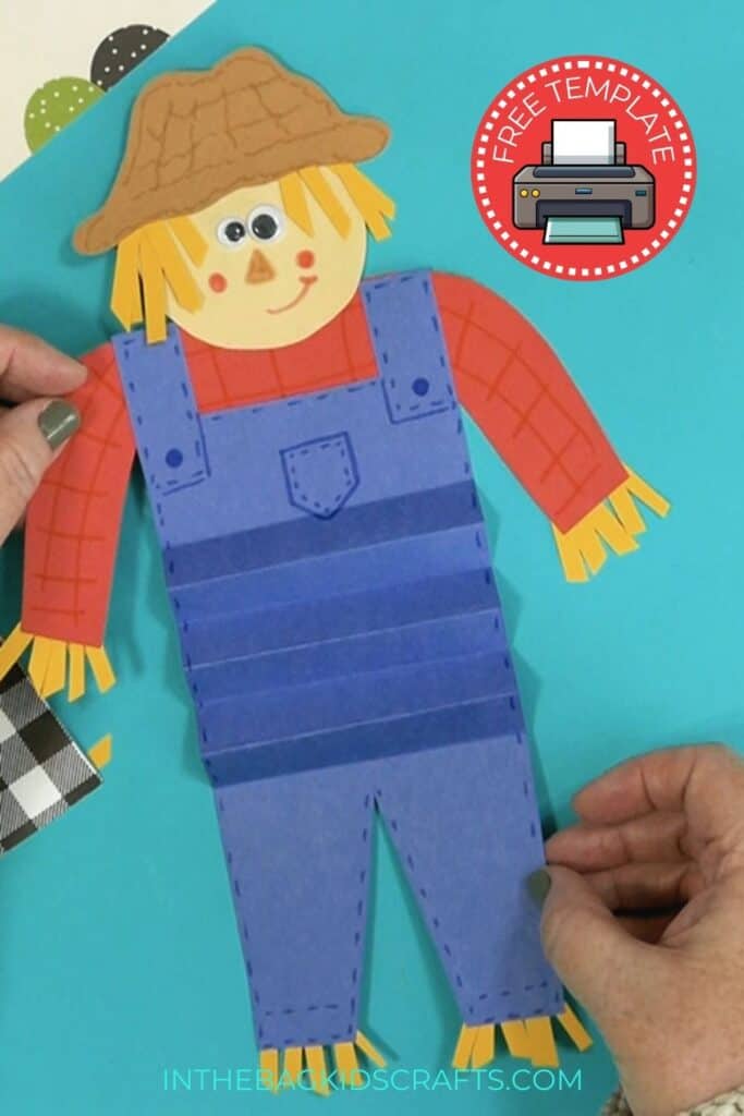 An image showing a paper scarecrow craft, perfect as an easy fall craft for kids to enjoy making.