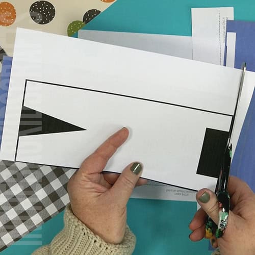 An image showing a paper scarecrow craft, perfect as an easy fall craft for kids to enjoy making.