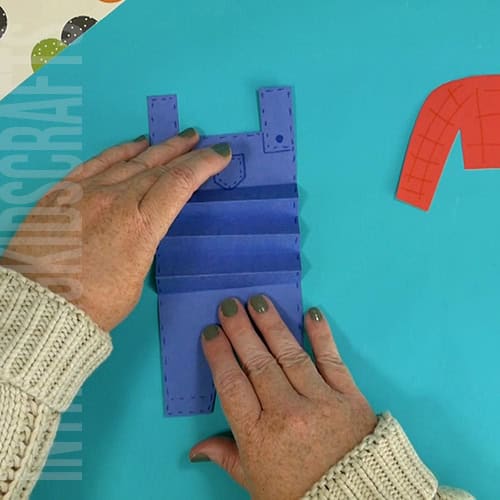 An image showing a paper scarecrow craft, perfect as an easy fall craft for kids to enjoy making.