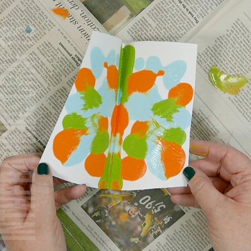 Colorful turkey craft for kids featuring a free turkey outline, ideal as a Thanksgiving craft for preschool and kindergarten children. squish painting the turkey feathers