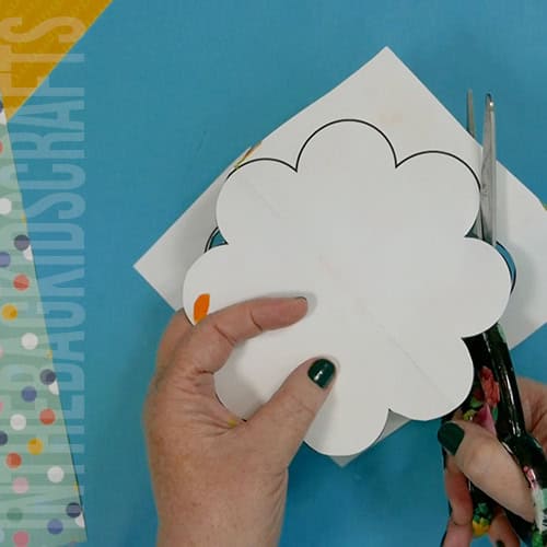 Colorful turkey craft for kids featuring a free turkey outline, ideal as a Thanksgiving craft for preschool and kindergarten children. cutting out the turkey feathers