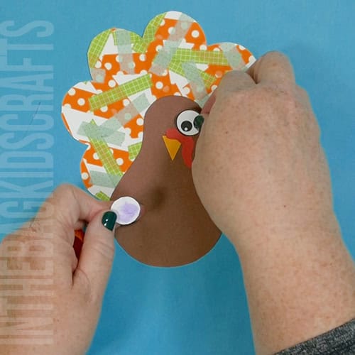 Colorful turkey craft for kids featuring a free turkey outline, ideal as a Thanksgiving craft for preschool and kindergarten children. assemble the turkey body