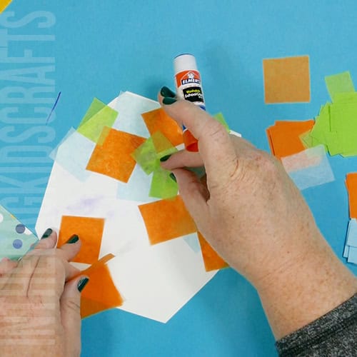 Colorful turkey craft for kids featuring a free turkey outline, ideal as a Thanksgiving craft for preschool and kindergarten children. tissue mosaic turkey feathers