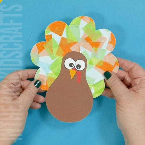 Colorful turkey craft for kids featuring a free turkey outline, ideal as a Thanksgiving craft for preschool and kindergarten children. tissue paper mosaic feathers Thanksgiving turkey art