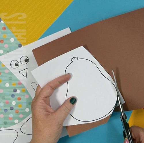 A colorful and simple turkey craft for kids featuring a cut-and-paste design, ideal for preschool craft and fall-themed Thanksgiving activities. step 1 cutting out the turkey