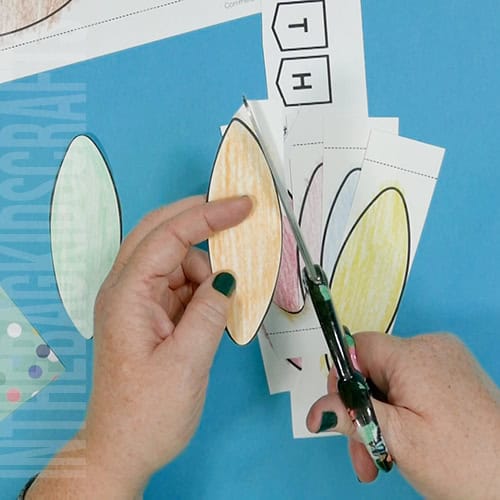 A colorful, kid-friendly turkey craft for Thanksgiving featuring a free printable template, perfect for a gratitude-themed craft for kids. step 2 cutting out the pieces