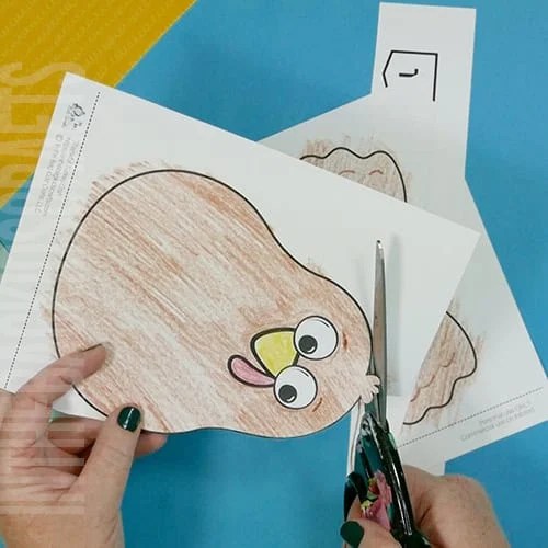 A colorful, kid-friendly turkey craft for Thanksgiving featuring a free printable template, perfect for a gratitude-themed craft for kids. step 2 cutting out the parts