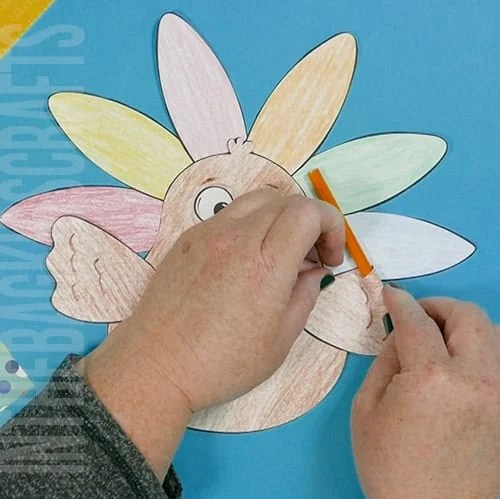 A colorful, kid-friendly turkey craft for Thanksgiving featuring a free printable template, perfect for a gratitude-themed craft for kids. step 4 prepping the wings