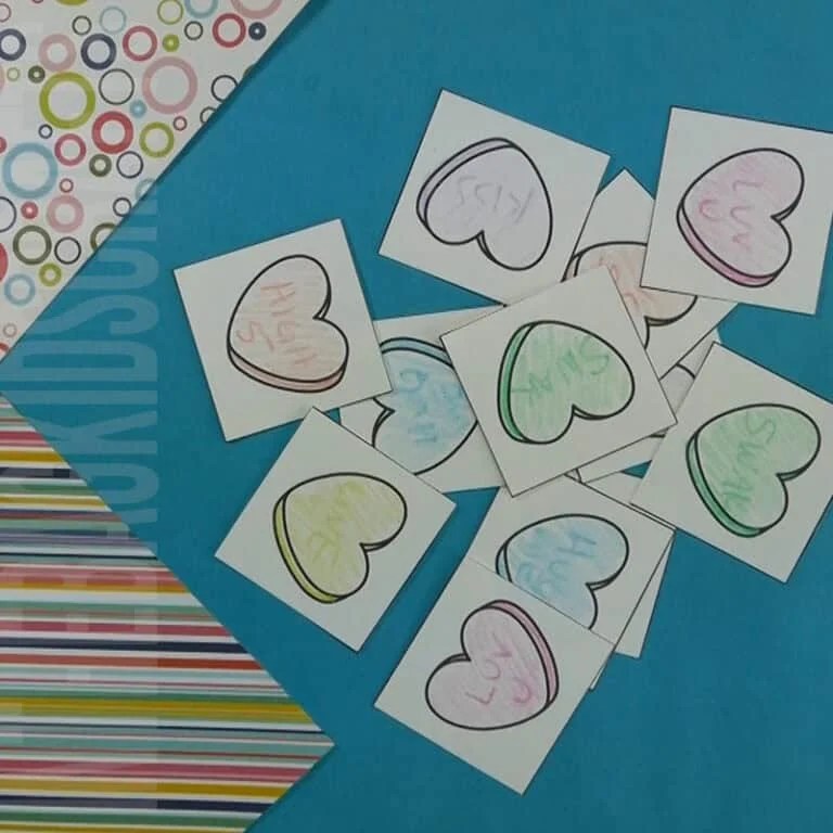 A collection of colorful heart-shaped cards laid out on a blue background, perfect for a Valentine game and engaging Valentine's Day activity for kids.