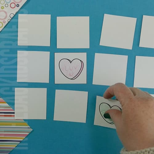 A collection of colorful heart-shaped cards laid out on a blue background, perfect for a Valentine game and engaging Valentine's Day activity for kids.