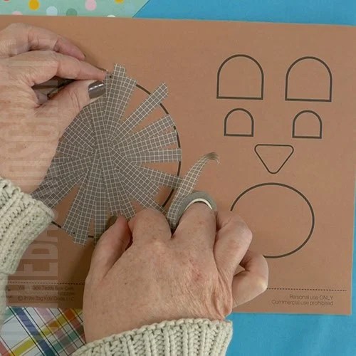 Colorful paper bear craft for kids with googly eyes, washi tape details, and crafting supplies, perfect for a fun fine motor activity.  step 1