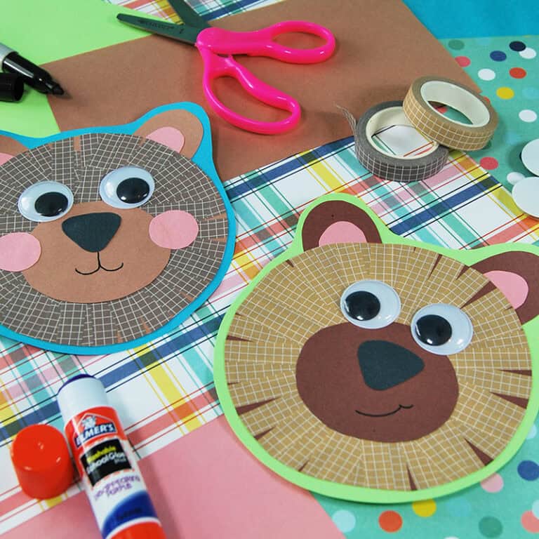 Colorful paper bear craft for kids with googly eyes, washi tape details, and crafting supplies, perfect for a fun fine motor activity.