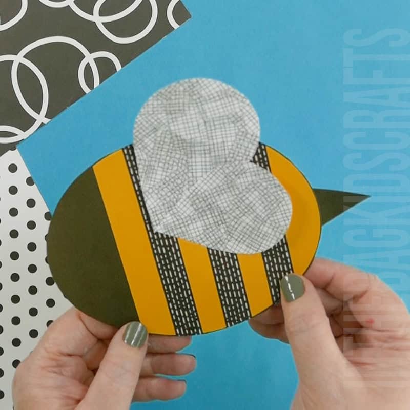 A cheerful preschool bee craft made from paper with stitched edges, designed as a fun fine motor activity for young kids to practice cutting and hand coordination skills.