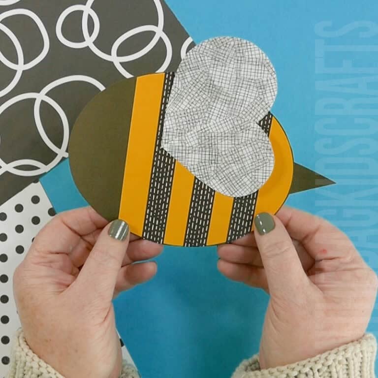 A cheerful preschool bee craft made from paper with stitched edges, designed as a fun fine motor activity for young kids to practice cutting and hand coordination skills.