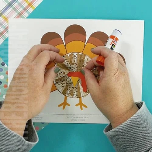 An image showing a preschool Thanksgiving turkey craft, designed as a fun and easy fine motor activity for kids. step 4