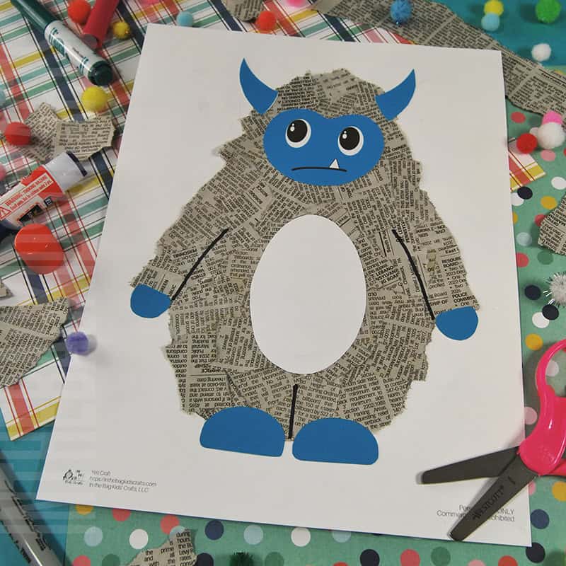 A completed yeti craft for kids made with torn newspaper pieces, featuring a blue face and horns, set against a winter-themed background, perfect as a fun winter craft activity.