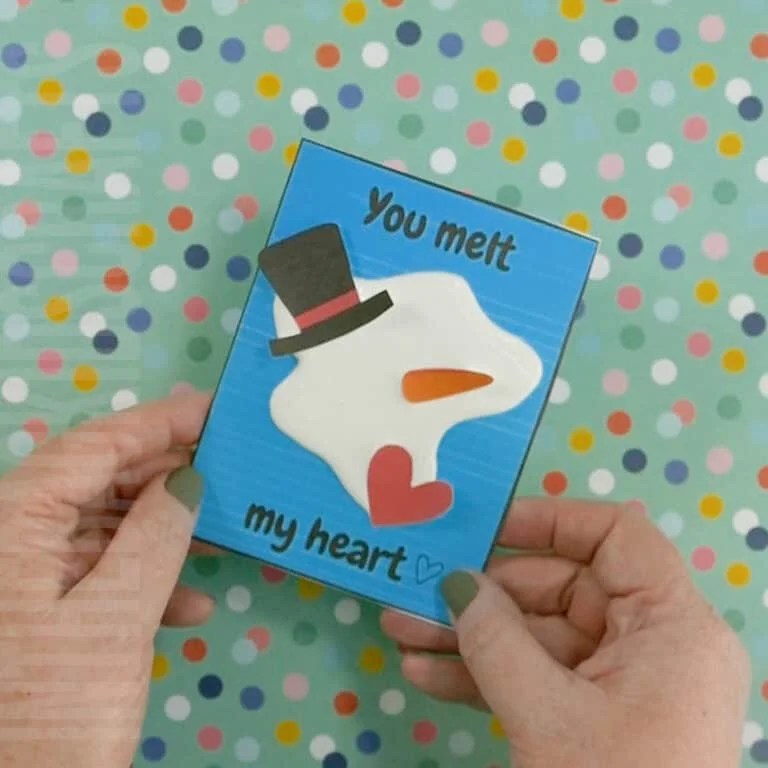 A handmade valentine card featuring a melted snowman design, perfect for a heartfelt Valentine's Day craft that kids and adults will love making.
