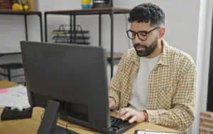 Business professional using a computer to leverage Microsoft Power Platform for business growth.