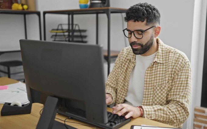 Business professional using a computer to leverage Microsoft Power Platform for business growth.