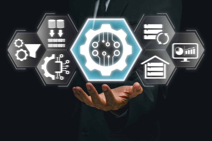 Digital data integration and automation icons with a hand holding a holographic interface.